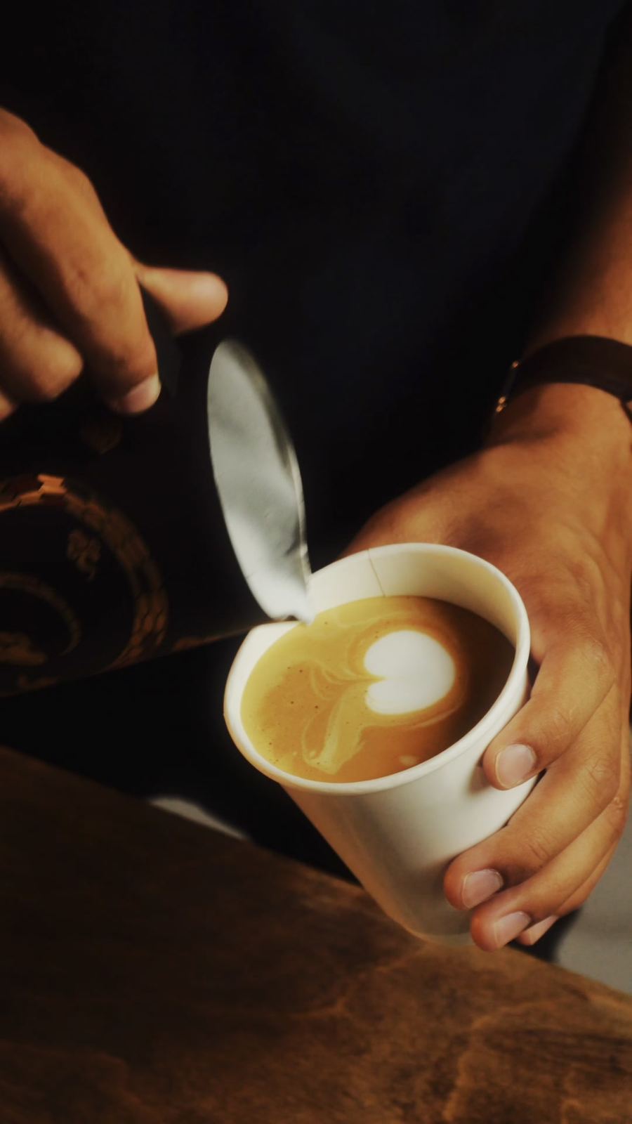 Barista pouring a latte at a brand activation