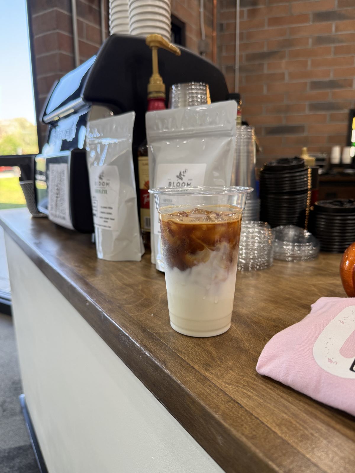 Iced latte and Bloom coffee bags on the cart