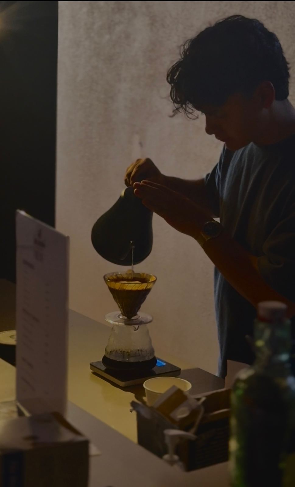 Barista doing a pour-over coffee at a Bloom event