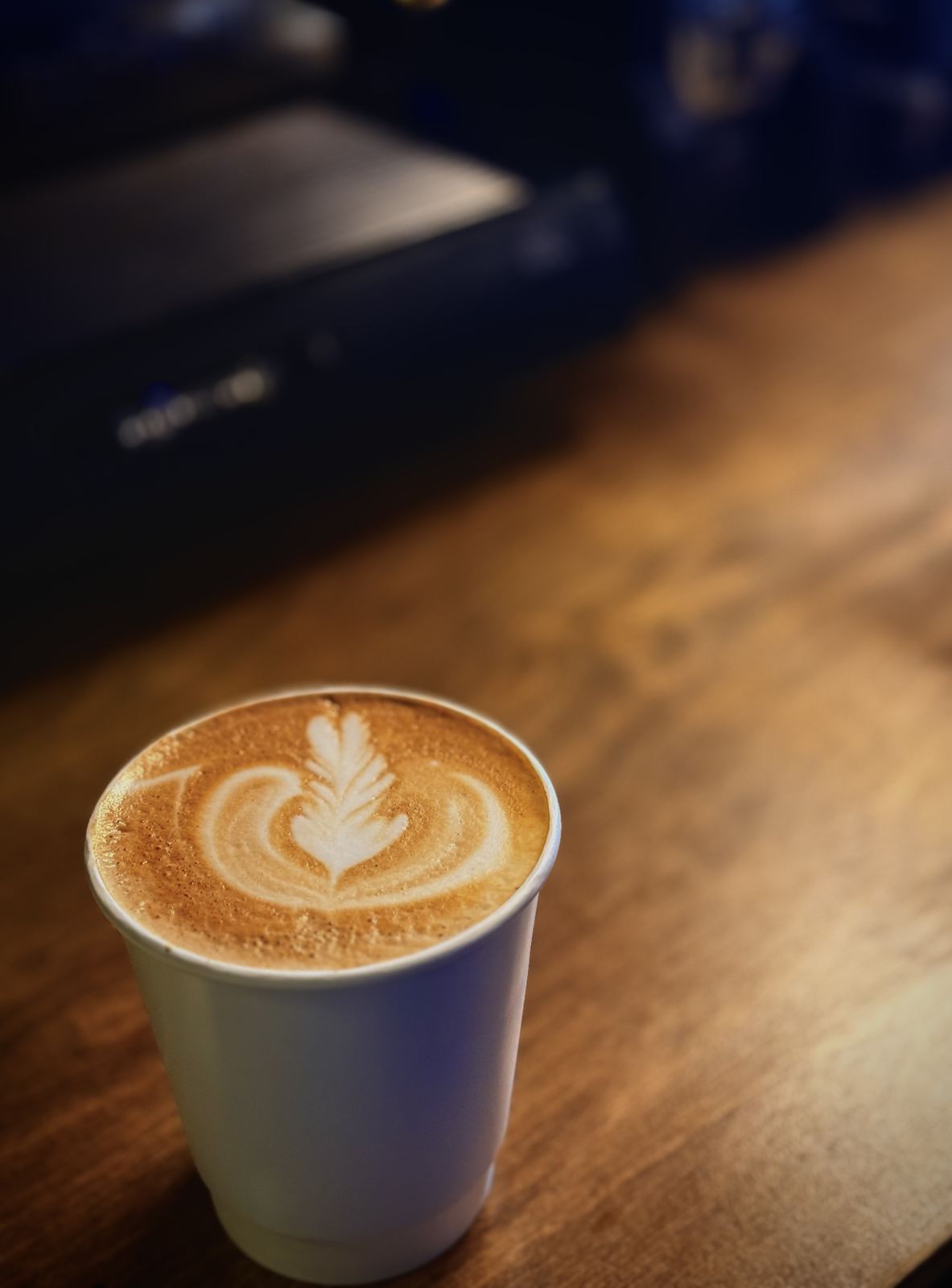 Latte on a wood counter at a Bloom wedding coffee bar